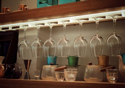 Elegant coffee bar setup with inverted wine glasses and brewing tools.